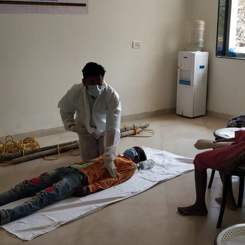 Kikstart clinician conducting a hands-on assessment during a Project DIA disability identification camp