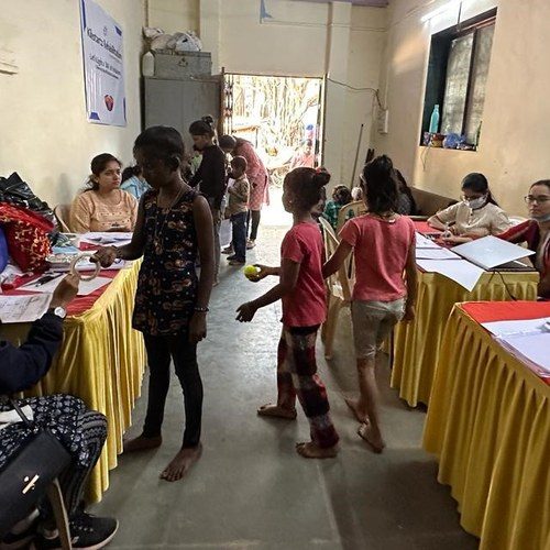 Children at registration desks during a Project DIA community identification camp