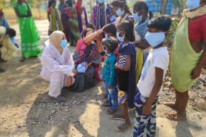 Kikstart team members engaging with children and families during a community outreach