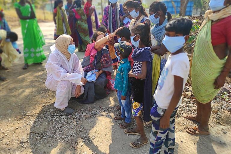 Kikstart team members engaging with children and families during a community outreach visit